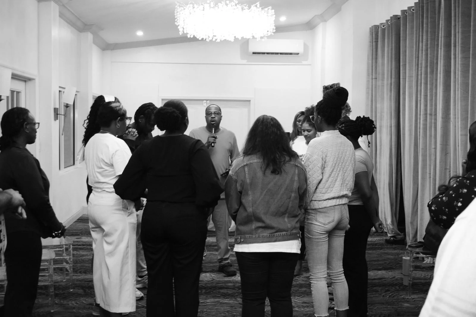People gathered for worship and reflection in a room.
