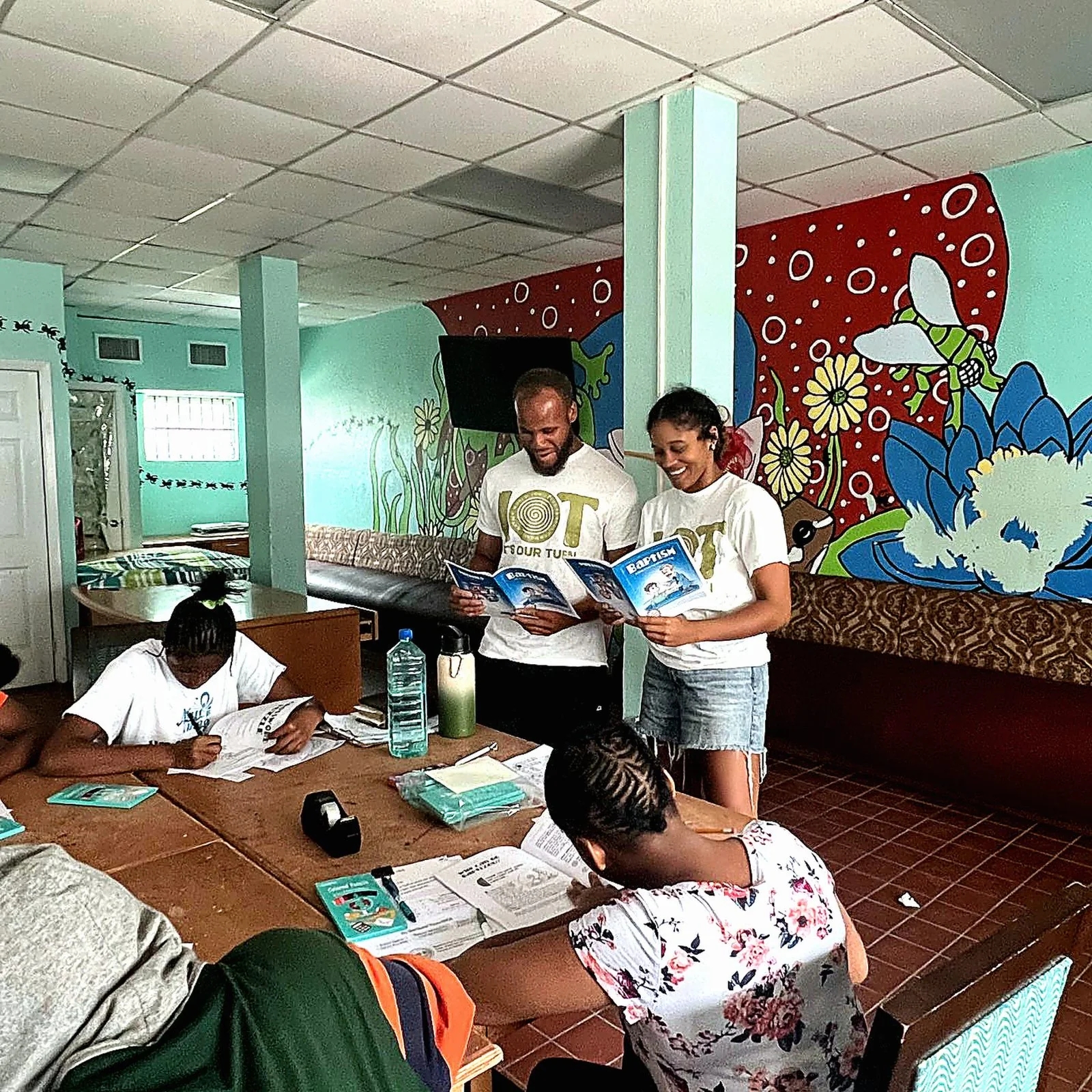 Adults and students gathered for a classroom discussion.
